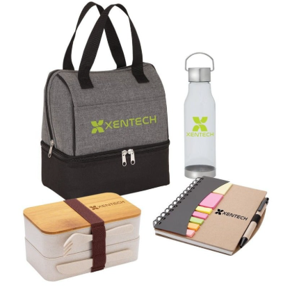 A collection of welcome kit items including a tote bag, mug, and notebook.